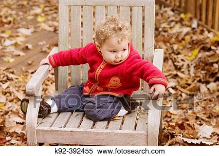 One year old boy sitting on a deck chair. View Large Photo Image Stock Photography - One year old boy sitting on a deck chair.. Fotosearch