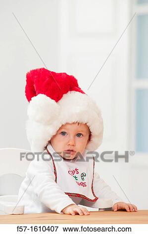 Stock Photo - One year old boy wearing a Santa hat. Fotosearch
