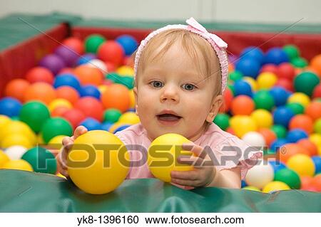 One Year Old Caucasian Baby Girl in Playground with Toy Balls View Large Photo Image Stock Image - One Year Old Caucasian Baby Girl in Playground with Toy Balls. Fotosearch