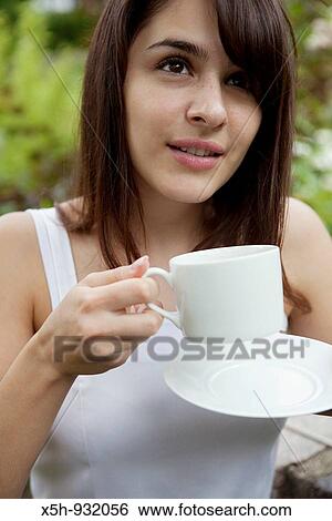 one young woman drinking coffee outdooe View Large Photo Image Stock Photograph - one young woman drinking coffee outdooe. Fotosearch