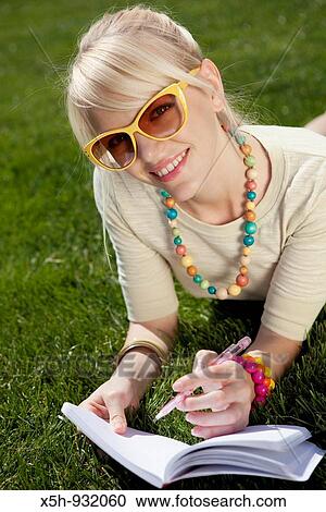 one young woman reading book on the grass in summer View Large Photo Image Stock Image - one young woman reading book on the grass in summer. Fotosearch
