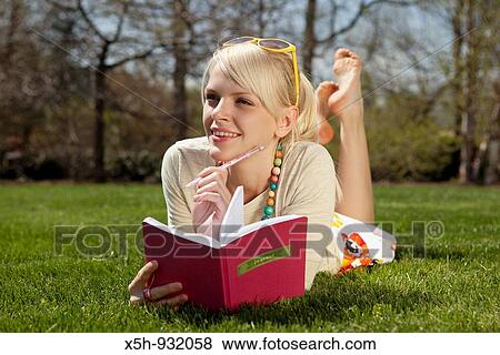 one young woman reading book on the grass outdoor in summer View Large Photo Image Stock Photo - one young woman reading book on the grass outdoor in summer. Fotosearch