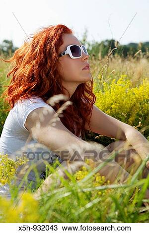one young woman sitting in the grass View Large Photo Image Stock Image - one young woman sitting in the grass. Fotosearch