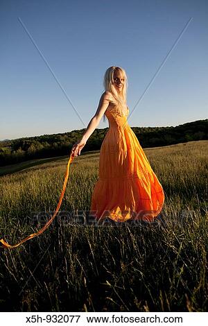 one young woman walking in a filed View Large Photo Image Stock Photo - one young woman walking in a filed. Fotosearch