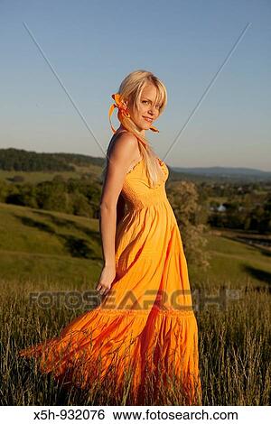 one young woman walkinh in a filed View Large Photo Image Stock Photograph - one young woman walkinh in a filed. Fotosearch
