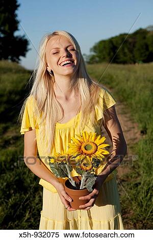 Stock Photography - one young woman with sun flower. Fotosearch