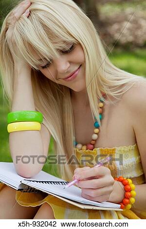 One young woman with textbook outdoor View Large Photo Image Stock Image - One young woman with textbook outdoor. Fotosearch