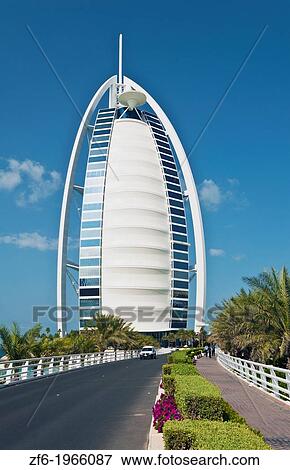 Stock Photo - Only 7 star hotel called the Burj Al Arab with tourists relaxing at water in Dubai in the UAE United Arab Emirates.. Fotosearch