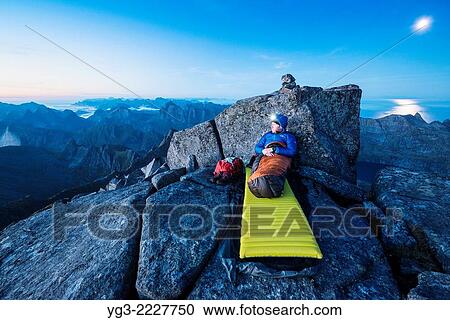 Open air mountain bivy on rocky summit of Hermannsdalstinden, Moskenesoy, Lofoten Islands, Norway. View Large Photo Image Stock Image - Open air mountain bivy on rocky summit of Hermannsdalstinden, Moskenesoy, Lofoten Islands, Norway.. Fotosearch