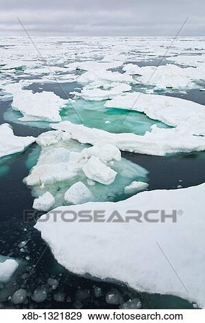 Stock Photo - Open leads surrounded by multi-year ice floes in the Barents Sea between Edgeoya Edge Island and Kong Karls Land in the Svalbard Archipelago, Norway. Fotosearch
