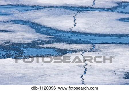Stock Photograph - Open leads surrounded by multi-year ice floes in the Barents Sea between Edgeya Edge Island and Kong Karls Land in the Svalbard Archipelago, Norway. Fotosearch