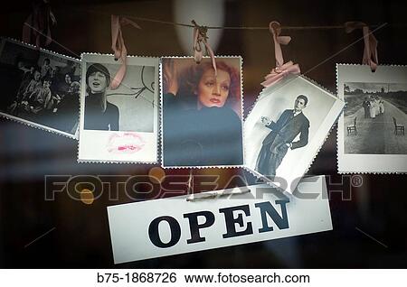 open sign on the door of a business decorated with photographs of artists View Large Photo Image Stock Photograph - open sign on the door of a business decorated with photographs of artists. Fotosearch