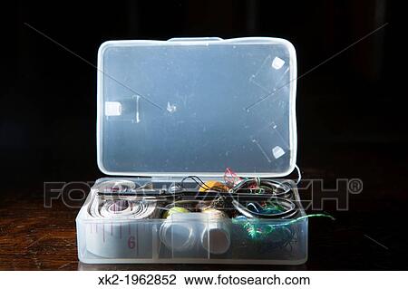 Stock Image - Opened plastic sewing small box. Fotosearch