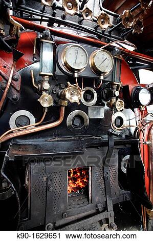 Operator's stand of an old steam engine of Rovos Rail with its pressure gauges, instruments and copper pipes, coal fire in the fire place, Pretoria, South Africa View Large Photo Image Stock Image - Operator's stand of an old steam engine of Rovos Rail with its pressure gauges, instruments and copper pipes, coal fire in the fire place, Pretoria, South Africa. Fotosearch