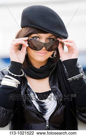 Optimistic young woman portrait with a beret and sunglasses View Large Photo Image Stock Image - Optimistic young woman portrait with a beret and sunglasses. Fotosearch