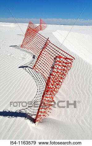 Stock Photo - Orange fence prevents erosion at White Sands National Monument New Mexico. Fotosearch
