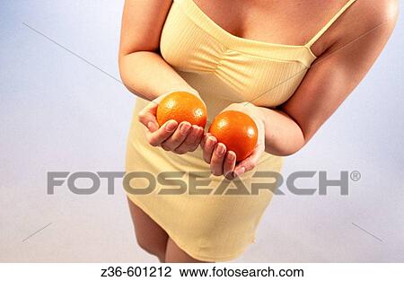Oranges in woman's hands View Large Photo Image Stock Image - Oranges in woman's hands. Fotosearch