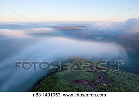Orographic cloud forms around the summit of Pen-Y-Fan in The Brecon Beacons National Park, Powys, Wales, UK. View Large Photo Image Stock Image - Orographic cloud forms around the summit of Pen-Y-Fan in The Brecon Beacons National Park, Powys, Wales, UK.. Fotosearch