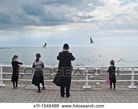 Orthodox hasidic jewish families on summer holiday in Aberystwyth Ceredigion Wales UK View Large Photo Image Stock Photo - Orthodox hasidic jewish families on summer holiday in Aberystwyth Ceredigion Wales UK. Fotosearch