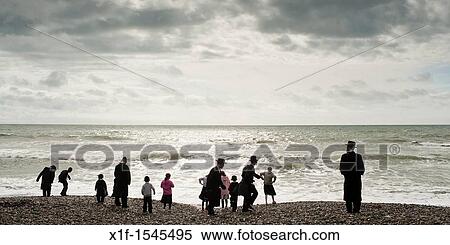 Orthodox Hassidic jews on summer holiday on the beach at Aberystwyth Wales UK View Large Photo Image Stock Photography - Orthodox Hassidic jews on summer holiday on the beach at Aberystwyth Wales UK. Fotosearch