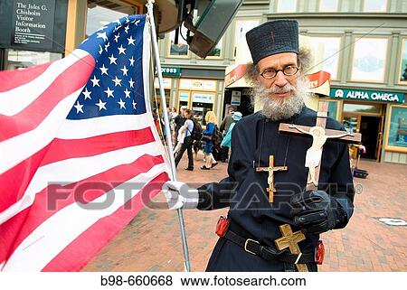 Orthodox novice monk with American flag in Cambridge, Harvard Square, Massachusetts, USA View Large Photo Image Stock Photo - Orthodox novice monk with American flag in Cambridge, Harvard Square, Massachusetts, USA. Fotosearch