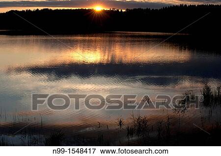 Stock Photo - Ouloj? rvi, Oulo river, midnight sun, Vaala, Finland. Fotosearch