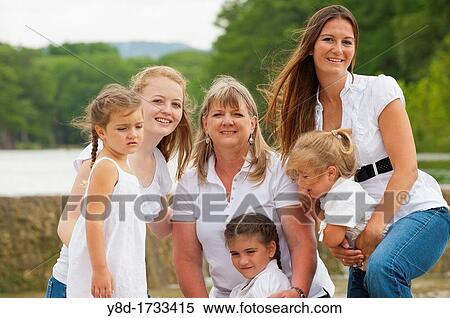 Outdoor females family portrait - grandmother with two adult daughters and three granddaughters View Large Photo Image Stock Photography - Outdoor females family portrait - grandmother with two adult daughters and three granddaughters. Fotosearch