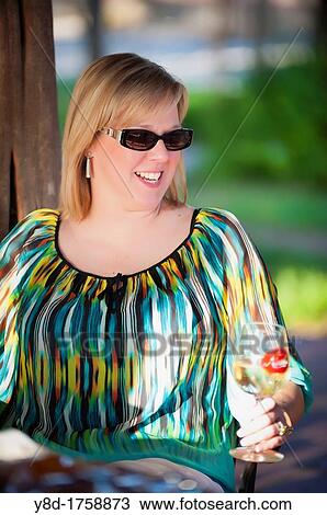 Outdoot portrait of 45 years old woman sitting relaxed on a table View Large Photo Image Stock Image - Outdoot portrait of 45 years old woman sitting relaxed on a table. Fotosearch