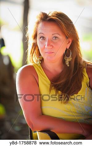 Outdoot portrait of 45 years old woman sitting relaxed on a table View Large Photo Image Stock Photo - Outdoot portrait of 45 years old woman sitting relaxed on a table. Fotosearch