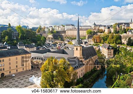 Stock Photo - Overview of Luxemburg City with the St. Johannes Church (Johanneskirche) and the river Alzette in the foreground, Luxemburg, Europe. Fotosearch