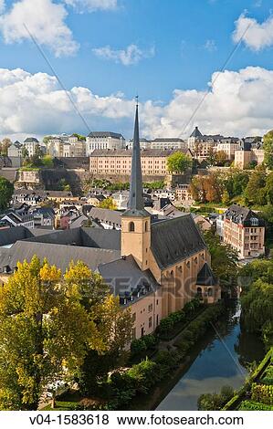 Stock Photo - Overview of Luxemburg City with the St. Johannes Church (Johanneskirche) and the river Alzette in the foreground, Luxemburg, Europe. Fotosearch