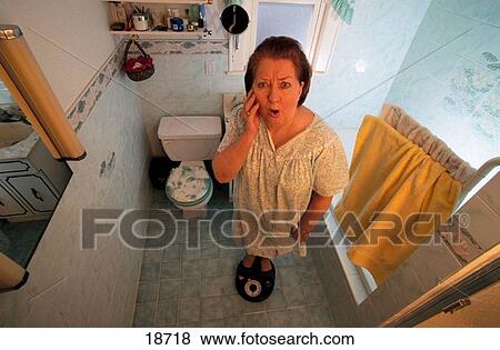 Overweight lady on scale View Large Photo Image Stock Photo - Overweight lady on scale. Fotosearch