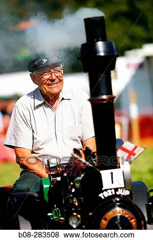 Owner with vintage steam engine at steam rally. Derbyshire. England View Large Photo Image Stock Photo - Owner with vintage steam engine at steam rally. Derbyshire. England. Fotosearch