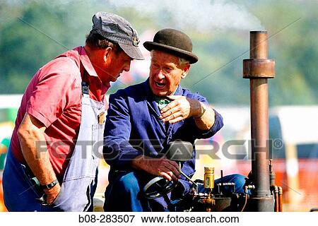 Owners with vintage steam engine at steam rally. Derbyshire. England View Large Photo Image Stock Photo - Owners with vintage steam engine at steam rally. Derbyshire. England. Fotosearch