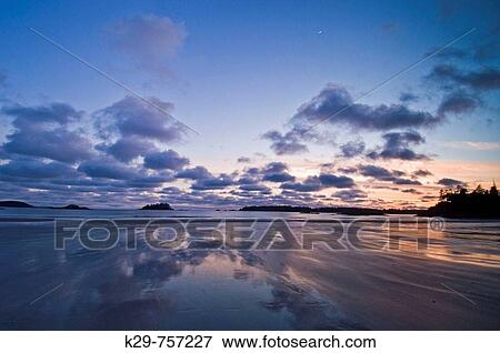Stock Photo - Pacific Rim sunset- MacKenzie Beach and outer islands at ebbing tide. Fotosearch