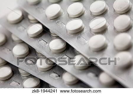 Packaged Pills in aluminium blisters stacked on each other. View Large Photo Image Stock Image - Packaged Pills in aluminium blisters stacked on each other.. Fotosearch