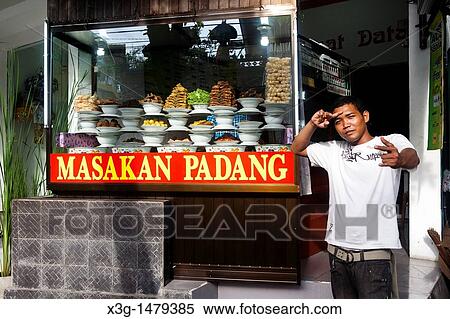 Padang food is very popular on Bali. The food is pre-prepared and placed on display where you go and choose what you would like to eat. Kuta, Bali, Indonesia View Large Photo Image Stock Photography - Padang food is very popular on Bali. The food is pre-prepared and placed on display where you go and choose what you would like to eat. Kuta, Bali, Indonesia. Fotosearch