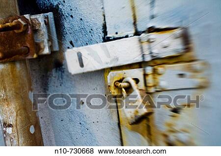 Padlock on an old rusty door View Large Photo Image Stock Photo - Padlock on an old rusty door. Fotosearch