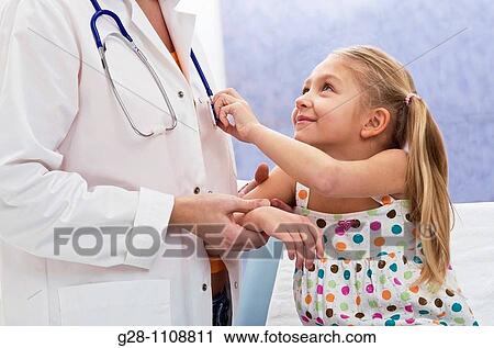 Stock Image - paediatric examination arm and or skin problem doctor with girl 7. Fotosearch