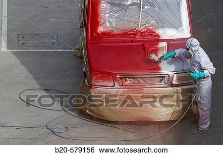Stock Photograph - Painting bodywork with spray gun. Fotosearch