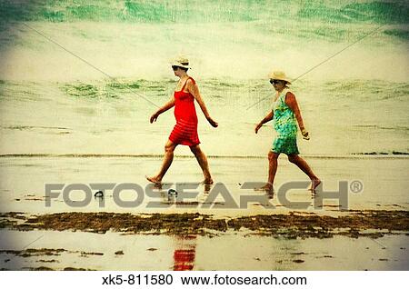 Pair of women walking along the beach in Cullera (Valencia, Spain) View Large Photo Image Stock Image - Pair of women walking along the beach in Cullera (Valencia, Spain). Fotosearch