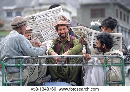 Pakistan, Baltistan, Skardu, Men reading newpapers on top of a bus View Large Photo Image Stock Image - Pakistan, Baltistan, Skardu, Men reading newpapers on top of a bus. Fotosearch