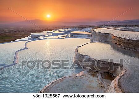 Stock Photo - Pamukkale, Turkey - the limestone terraces left by the flowing water, view at sunset time Pamukkale near Denizli. Fotosearch