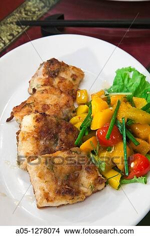 Pan fried Nha Trang sea bass with mango salad Wild Lotus Restaurant Hanoi Vietnam. View Large Photo Image Picture - Pan fried Nha Trang sea bass with mango salad Wild Lotus Restaurant Hanoi Vietnam.. Fotosearch