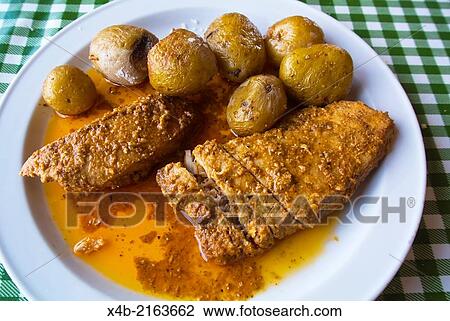 Stock Image - Pan fried tuna fish steaks and papas arrugadas the local potatoes, Yaiza, Lanzarote, Canary Islands, Spain, Europe.. Fotosearch