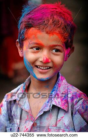 Stock Photography - Panjim Goa, India, child covered with colored powder at Holi feast parade. Fotosearch