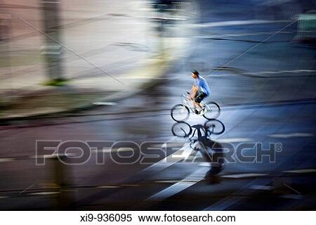 Panning shot of a cyclist by night, Berlin, Germany View Large Photo Image Stock Photography - Panning shot of a cyclist by night, Berlin, Germany. Fotosearch