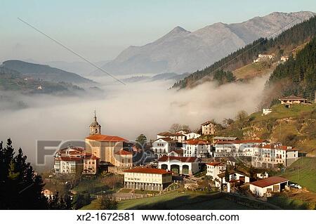 Stock Image - Panoramic view on a foggy morning in Regil, Guipuzcoa, Basque Country, Spain.. Fotosearch