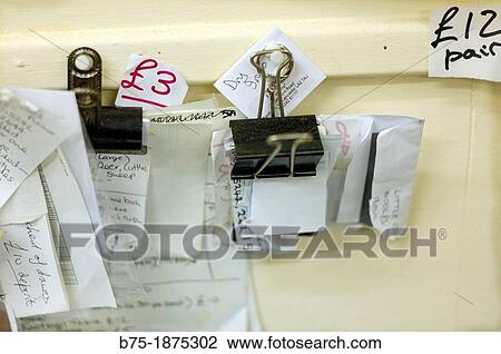 paper notes with clips hung on the wall View Large Photo Image Stock Image - paper notes with clips hung on the wall. Fotosearch