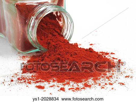 Picture - Paprika Powder, capsicum annuum against White Background.. Fotosearch